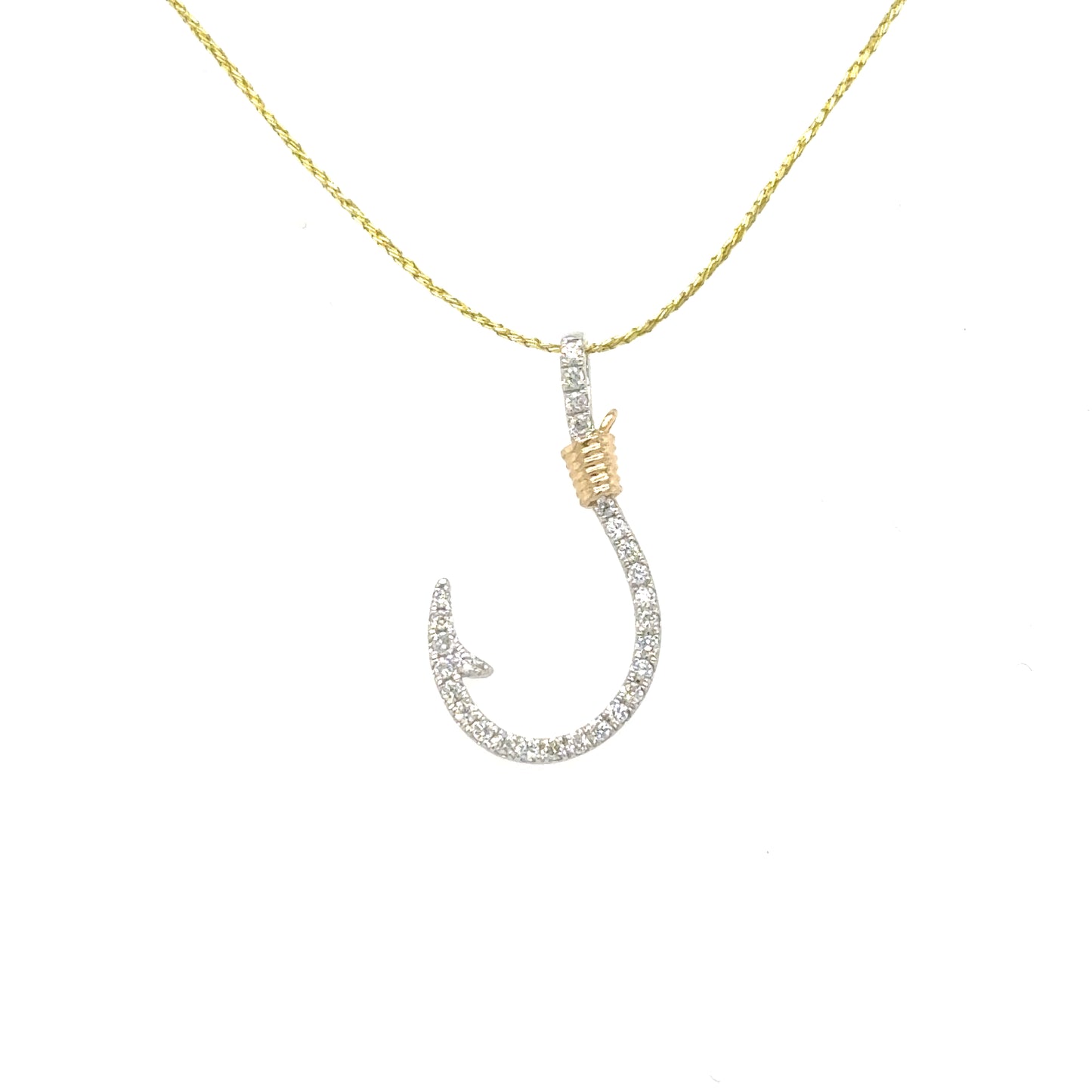 Small diamond pavé fishhook pendant in white gold with yellow-gold cable accent.