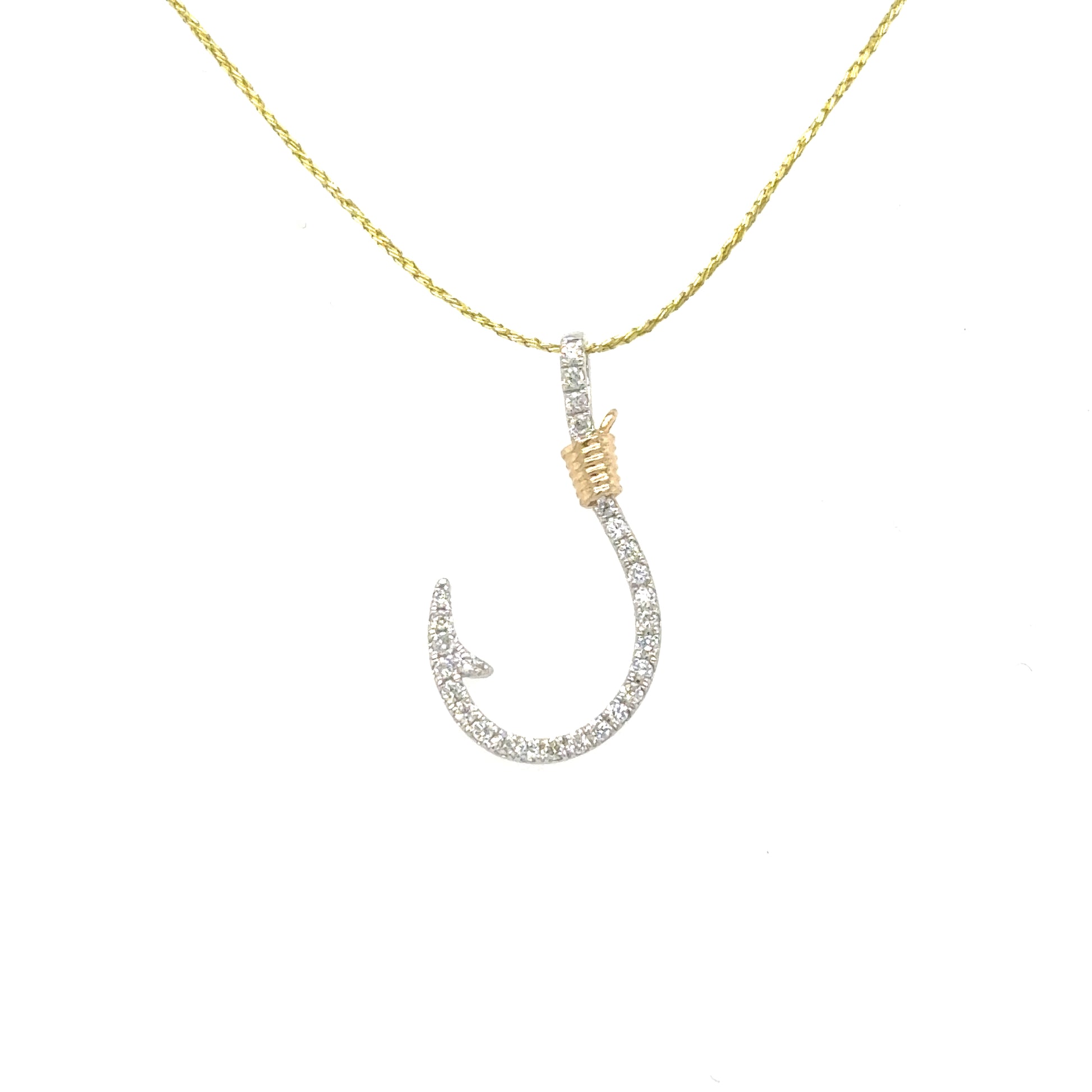 Small diamond pavé fishhook pendant in white gold with yellow-gold cable accent.