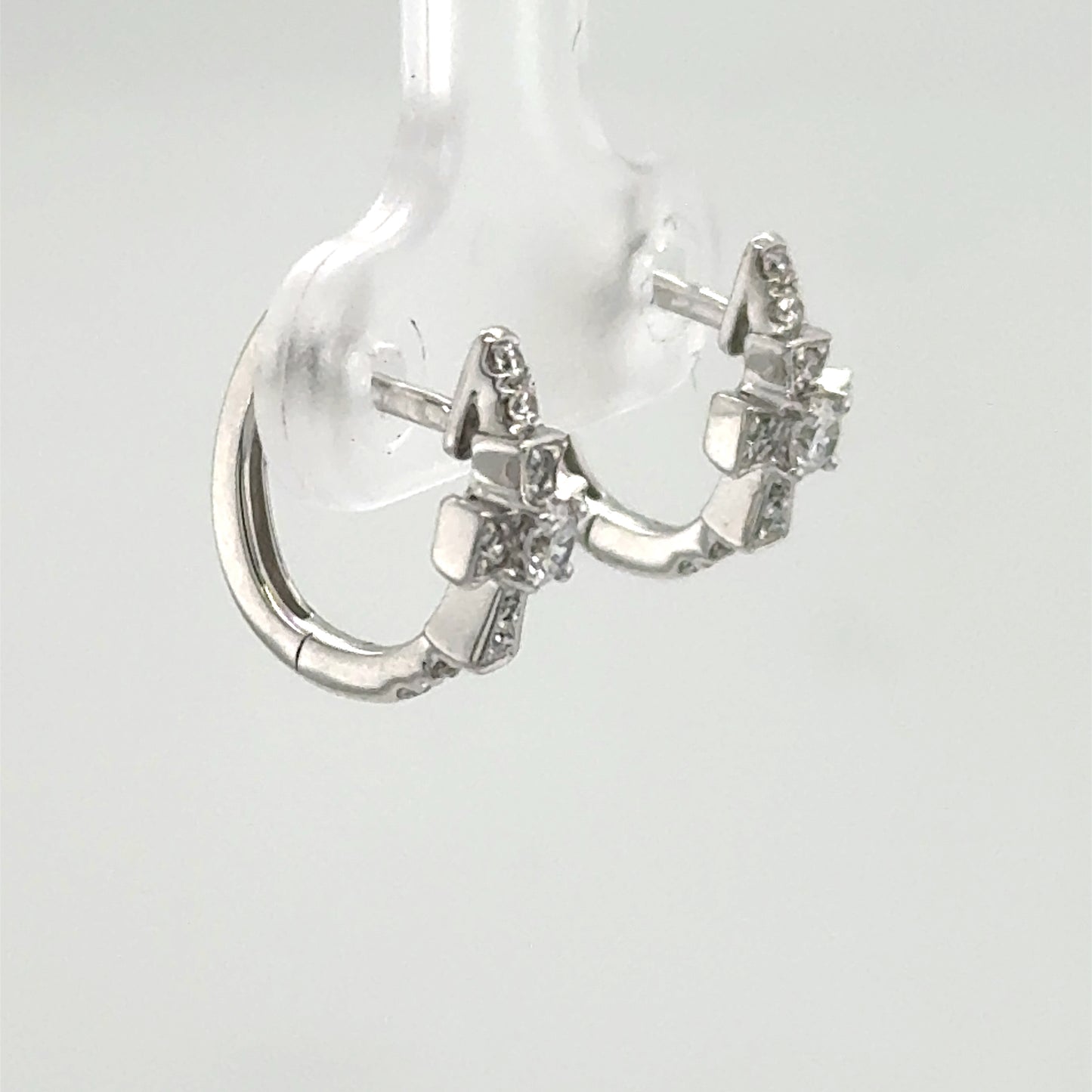 14K white gold huggie earrings with diamond cross motif and post backs.