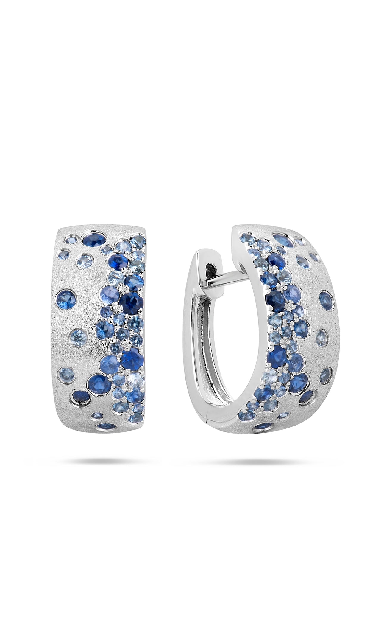 14K white gold huggie hoops with burnish-set blue sapphire confetti pattern.