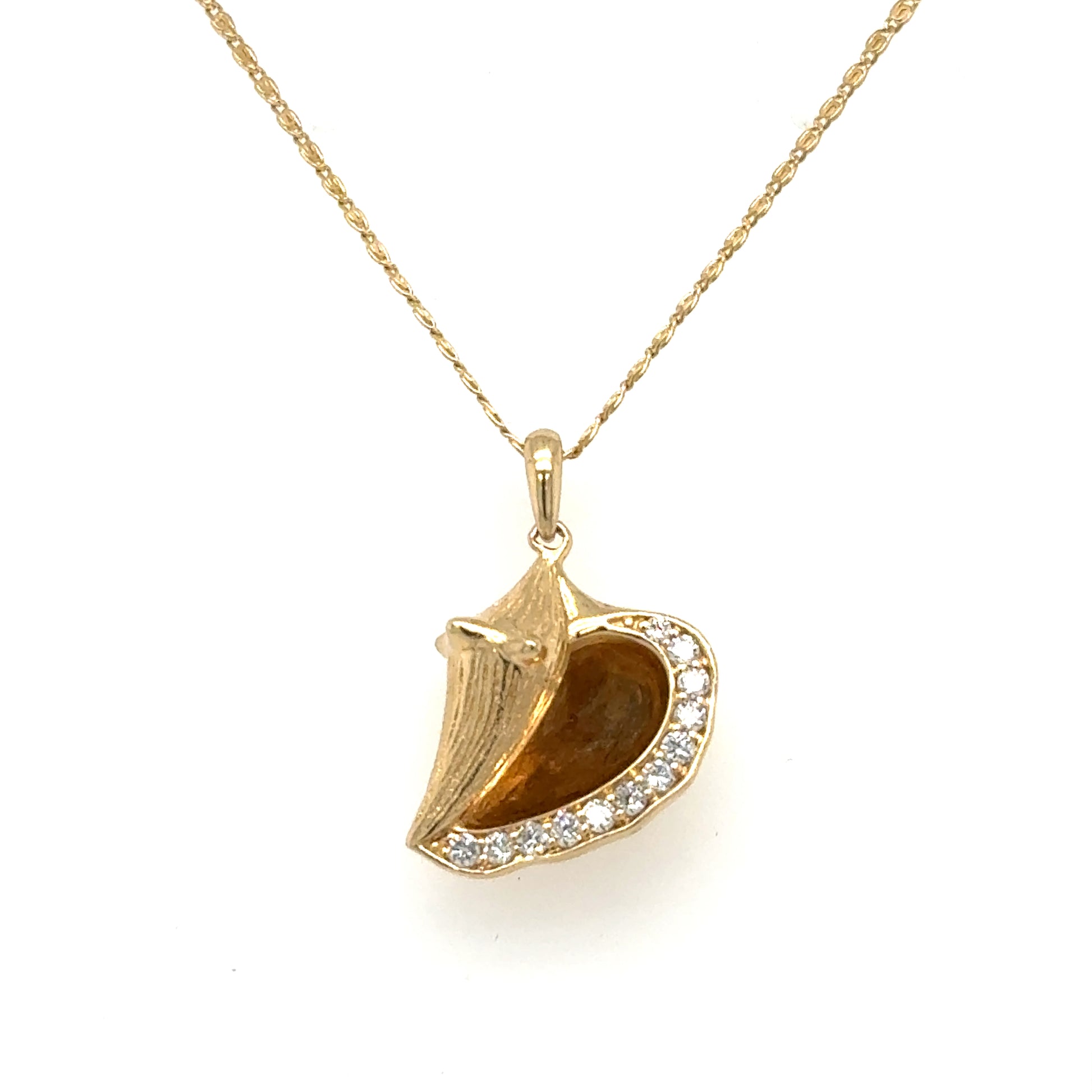 14K yellow gold conch shell pendant with pavé diamonds on serpentine chain.
