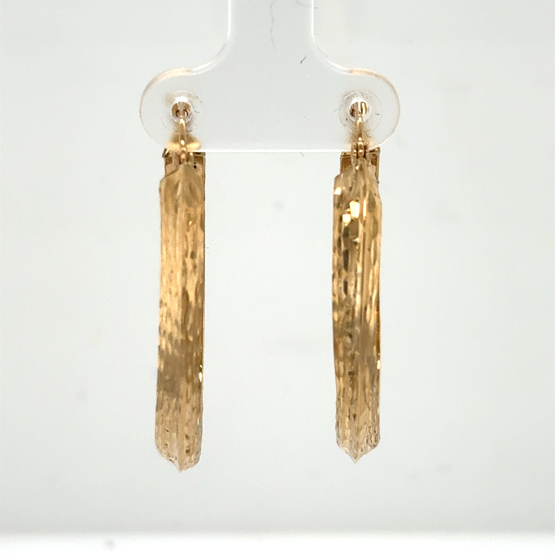 14K yellow gold oval hoop earrings with diamond-cut texture for pierced ears.