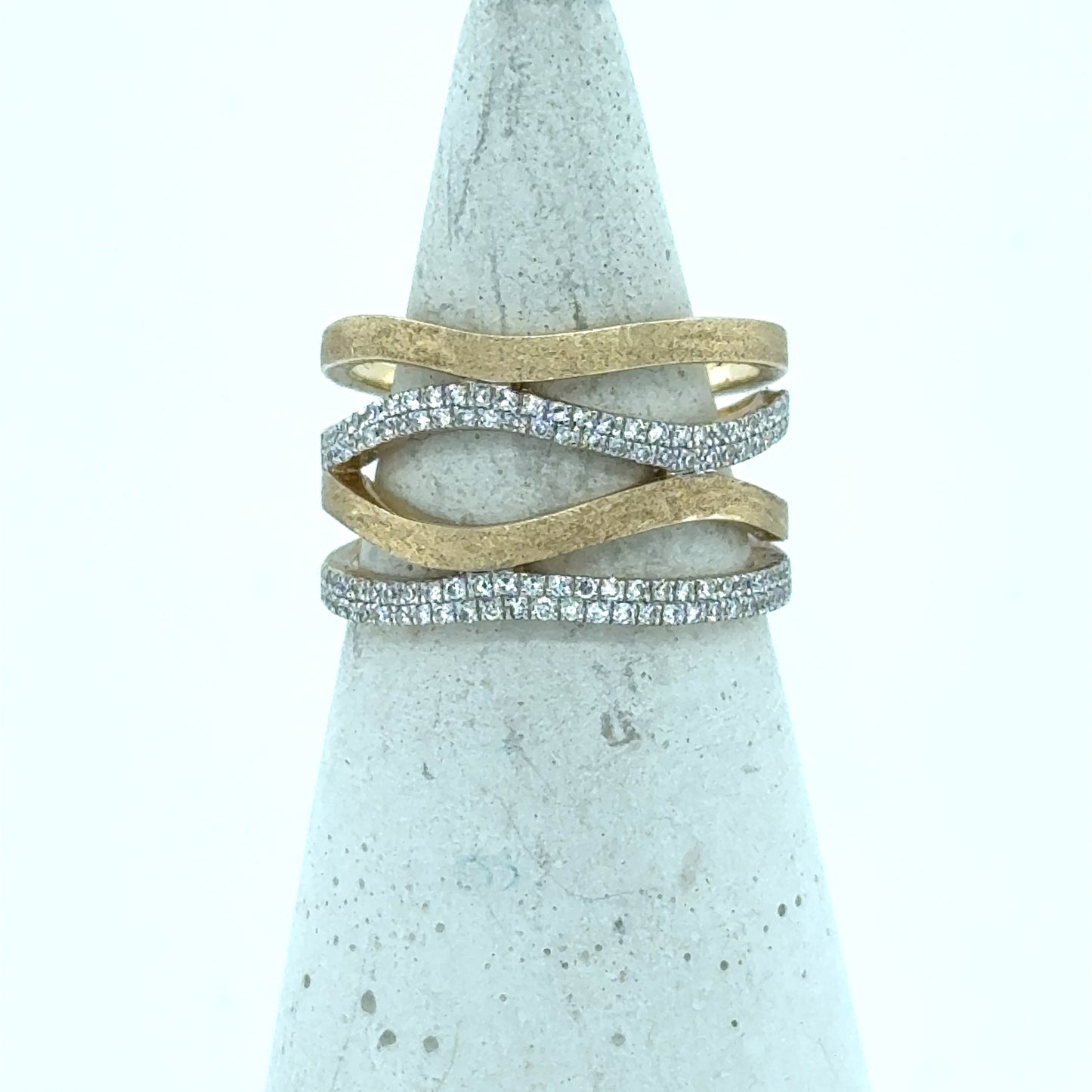 14K yellow gold freeform band with wavy open design and pavé diamonds.