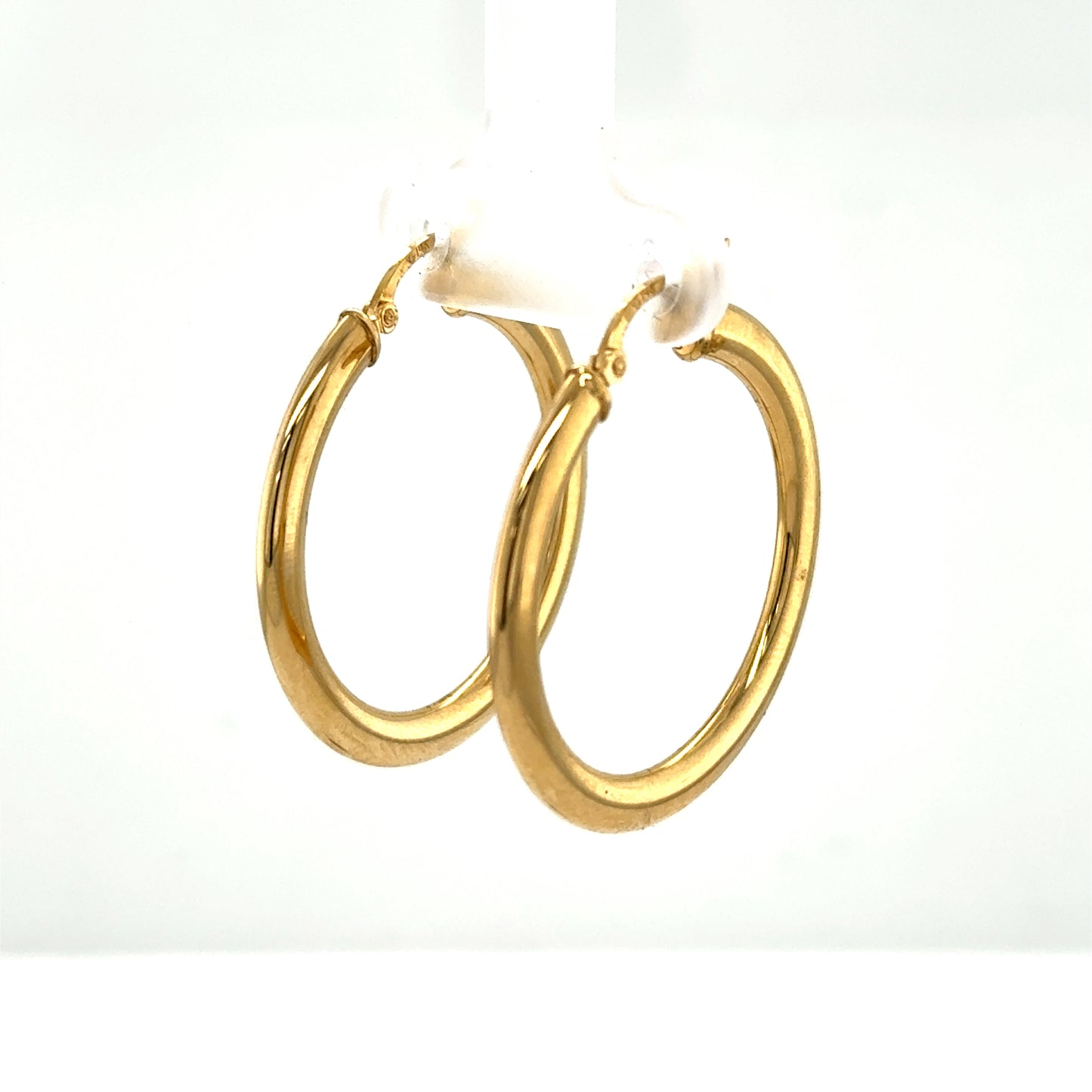 Polished yellow gold tube hoop earrings with hinged posts for pierced ears.