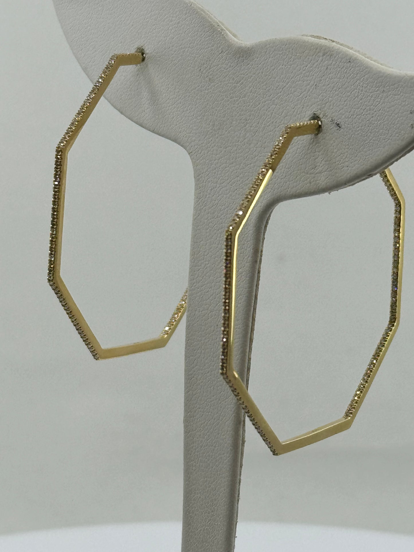 Octagon inside-out hoop earrings in 14K yellow gold with round diamonds.