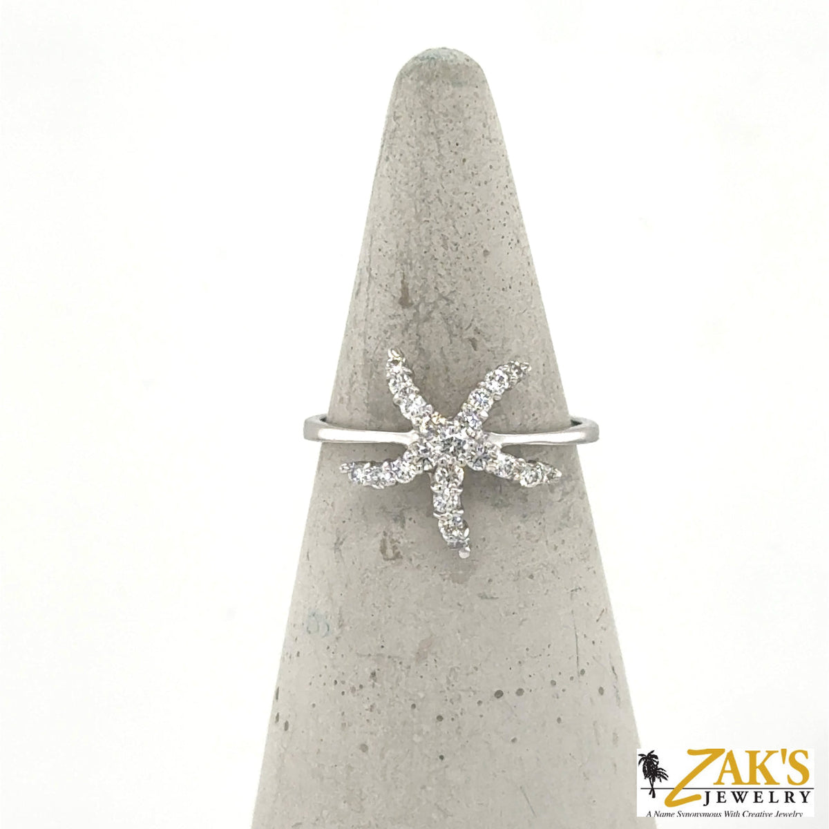 14K white gold ring with diamond starfish motif on a slim band.