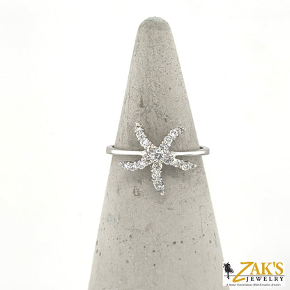 14K white gold ring with diamond starfish motif on a slim band.