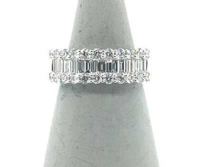 18K white gold band with center baguette diamonds flanked by round diamond rows.