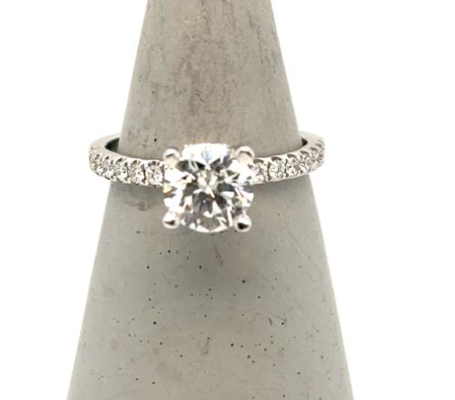 18K white gold engagement ring with round solitaire diamond and pavé diamond band.