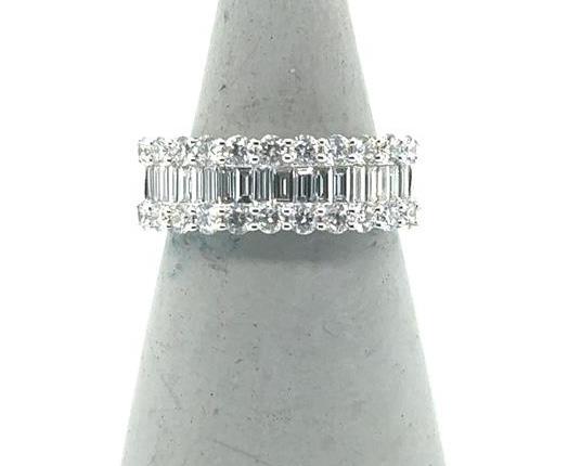 18K white gold band with center baguette diamonds flanked by round diamond rows.