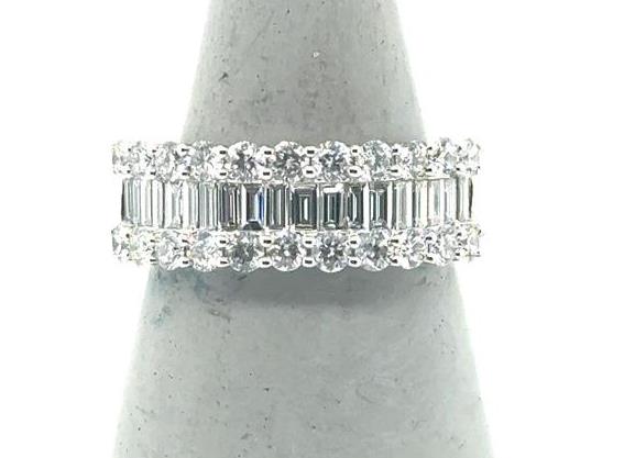 18K white gold band with center baguette diamonds flanked by round diamonds.