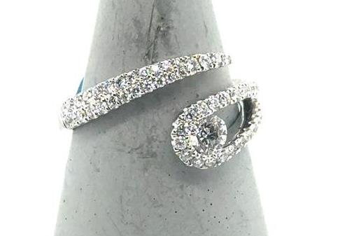 18K white gold bypass ring with pavé diamonds and a central round diamond.