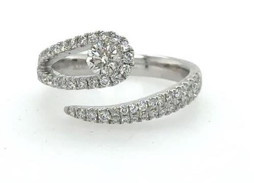 18K white gold bypass ring with pave band and central round diamond.