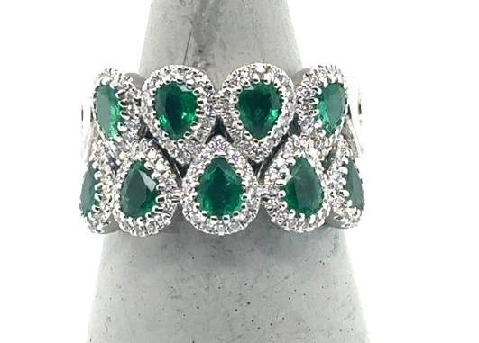 18K white gold ring with two rows of pear-shaped emeralds and diamond halos.