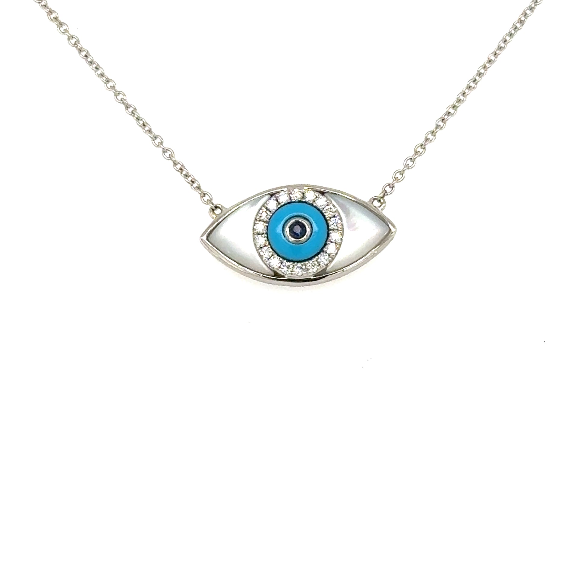 18K white gold evil eye pendant with mother-of-pearl, turquoise, diamonds, sapphire.