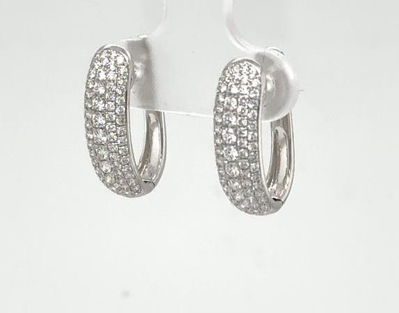 18K white gold oval hoop earrings pave-set with round diamonds, hinged backs.