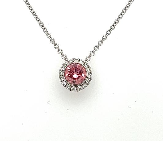 White gold pendant with round pink diamond bezel set, haloed by small white diamonds.