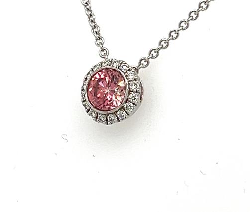 White gold pendant with bezel-set round pink diamond and white diamond halo.
