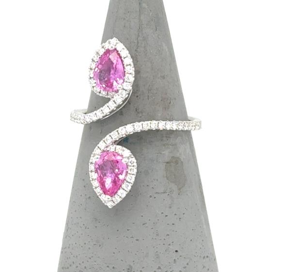 18K white gold bypass ring with pear-shaped pink sapphires and diamond halos.