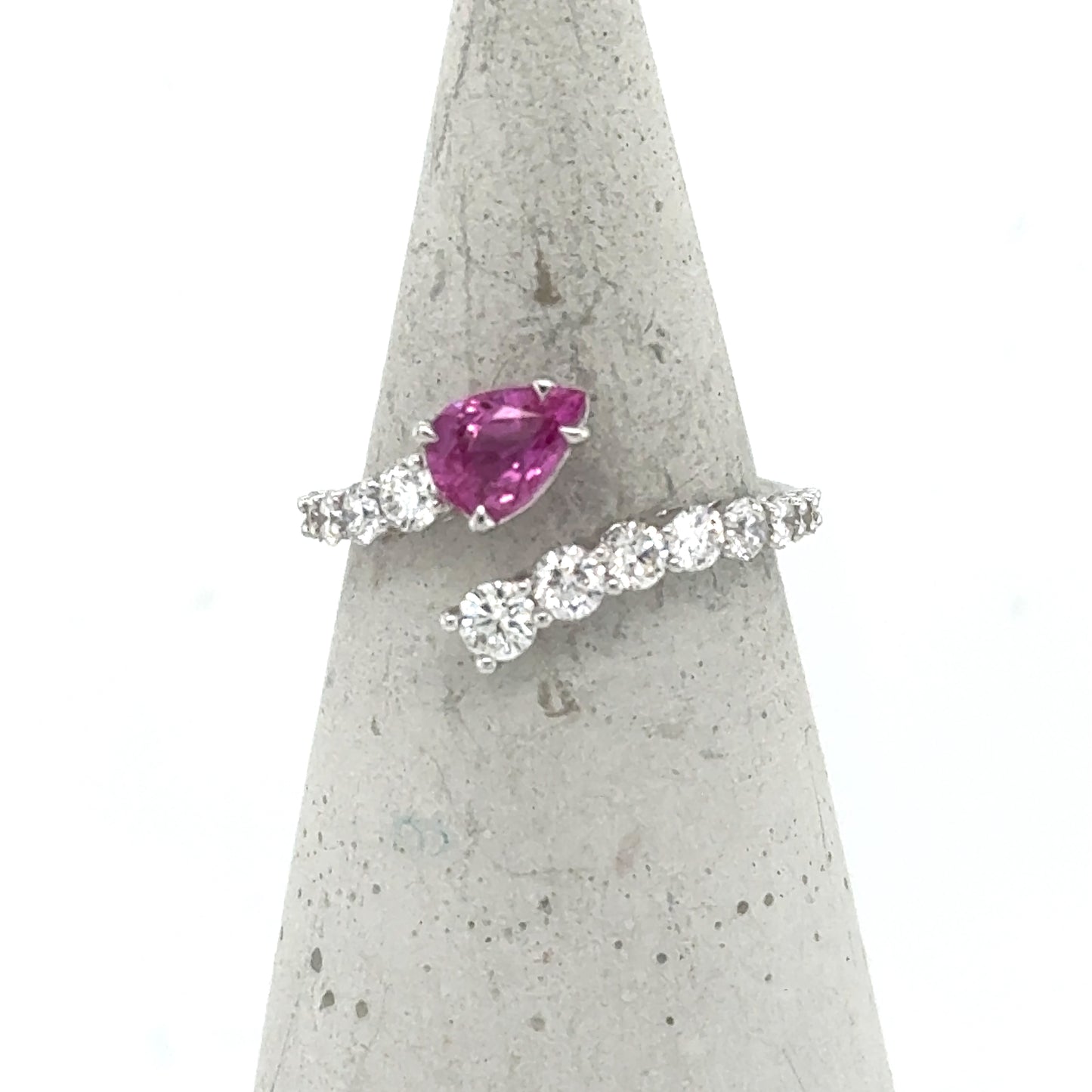 18K white gold bypass ring with pear-cut pink sapphire and diamond band.