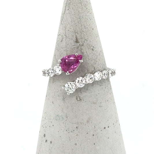 18K white gold bypass ring with pear-cut pink sapphire and diamond band.
