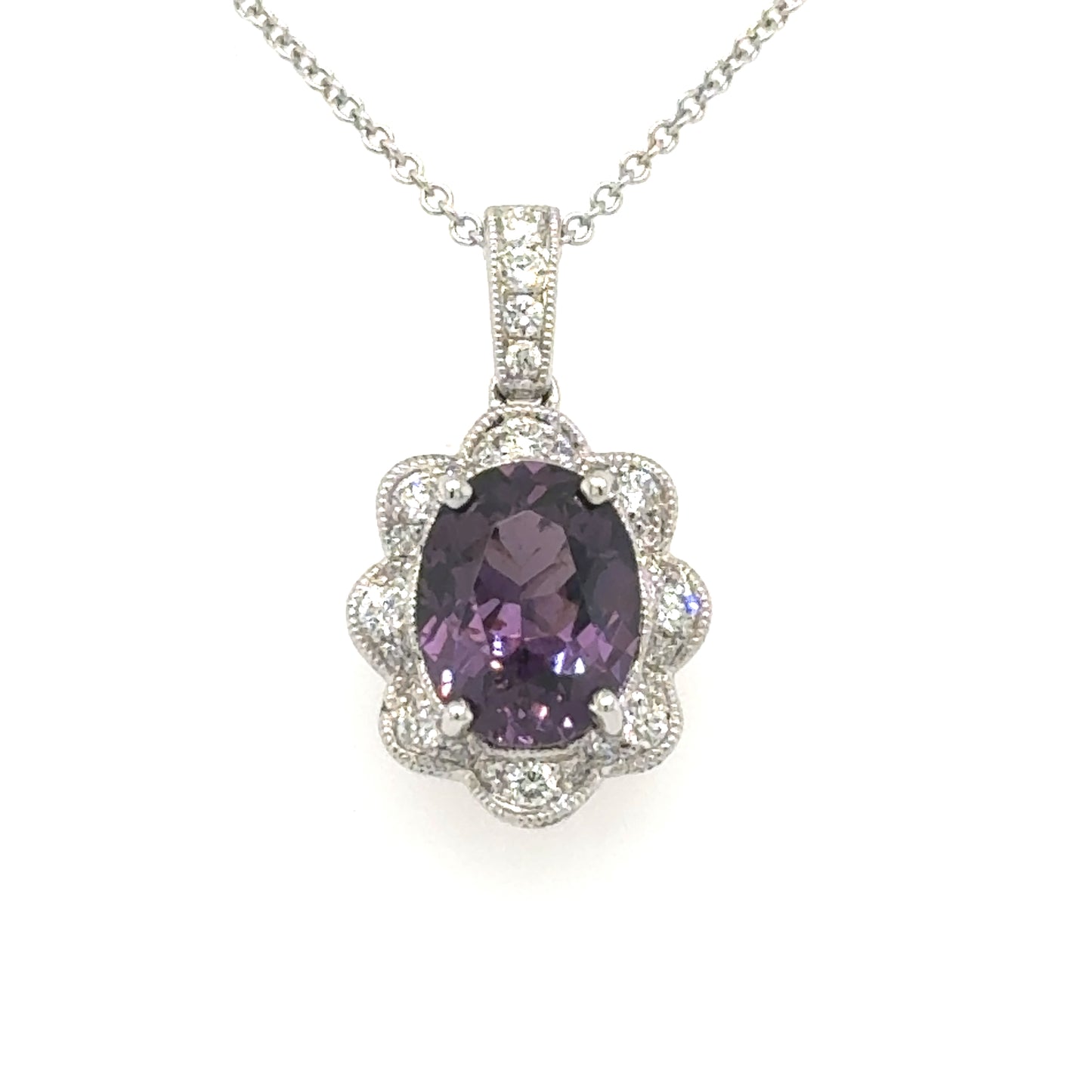 18K white gold pendant with oval purple spinel and scalloped diamond halo on rolo chain.