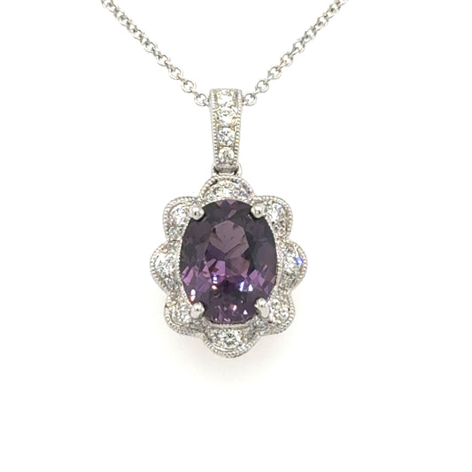 18K white gold pendant with oval purple spinel and scalloped diamond halo on rolo chain.
