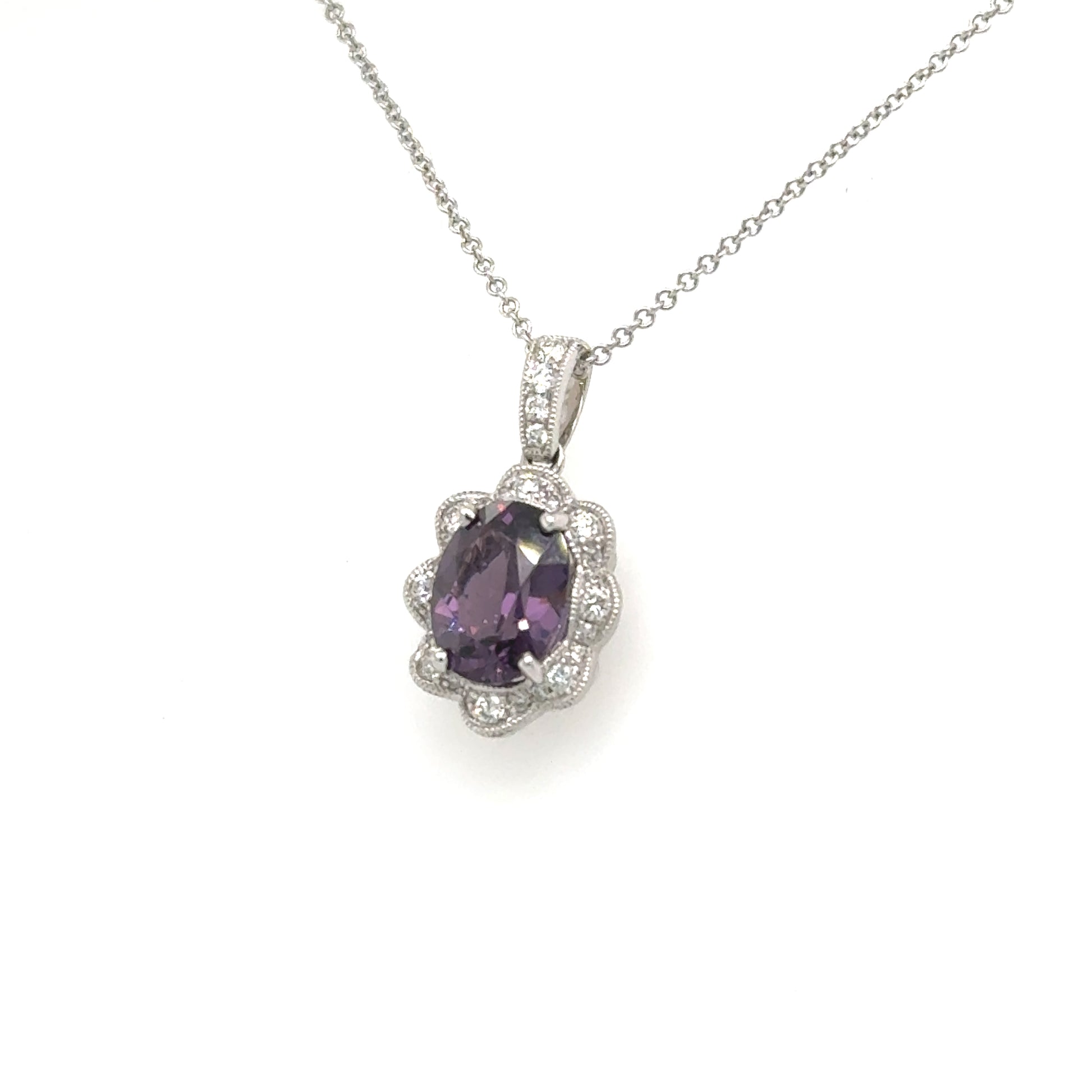 18K white gold pendant with oval purple spinel and scalloped diamond halo.