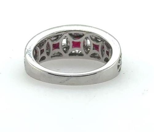 18K white gold band showing underside lattice with inset red rubies and diamonds.