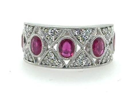 Wide 18K white gold band with five oval bezel-set rubies and pavé diamonds.