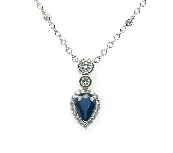 18K white gold necklace with pear-shaped blue sapphire halo pendant and diamonds.