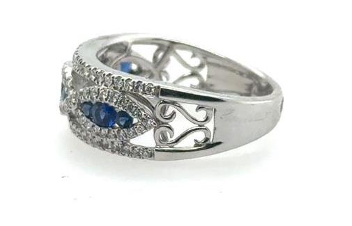 18K white gold band with marquise infinity motif, blue sapphires, and pavé diamonds.