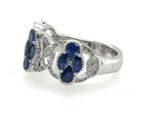 18K white gold ring with marquise and oval blue sapphires, diamond halos.