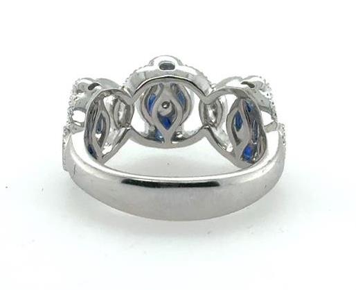 18K white gold ring with marquise and oval blue sapphires, diamond accents.