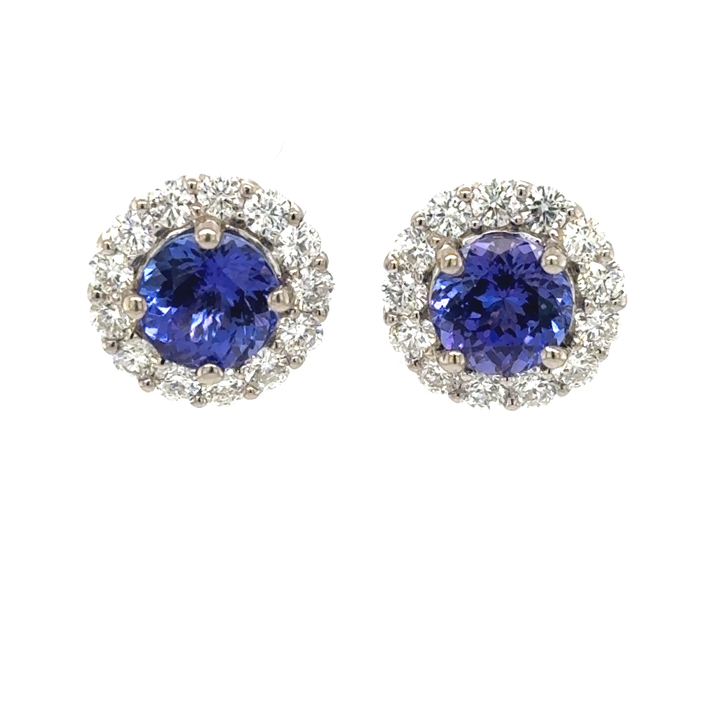 18K white gold stud earrings with round tanzanites and diamond halos.
