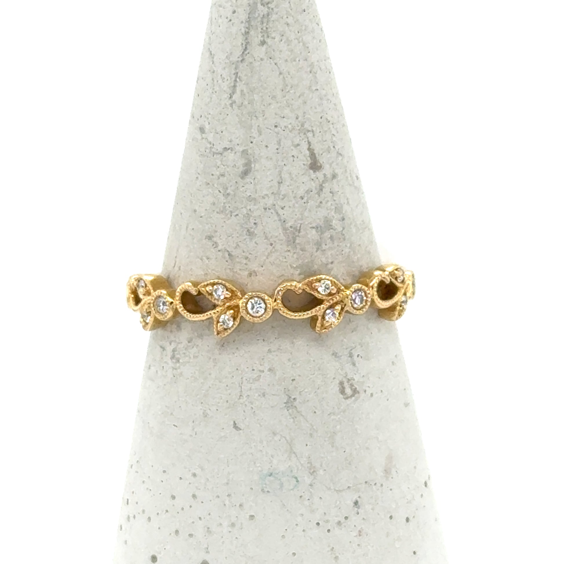 18K yellow gold band with milgrain leaf motifs and round diamond accents.