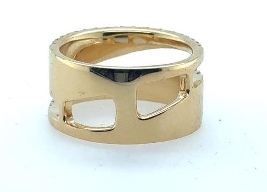 Wide 18K yellow gold band with geometric cutout windows and smooth finish.