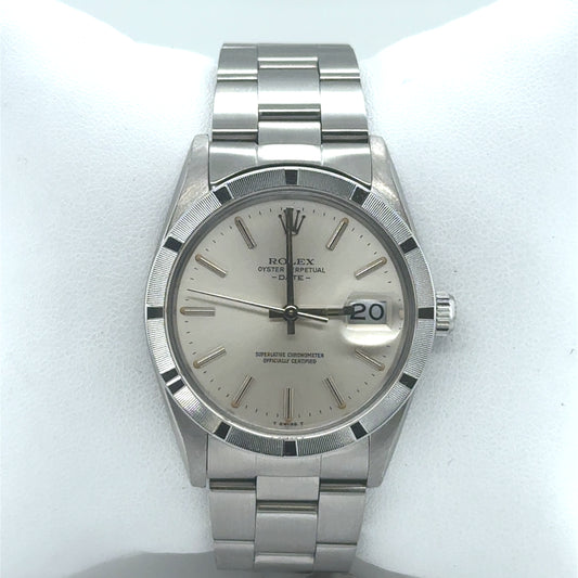 Stainless steel Rolex Date 34mm with silver dial, engine-turned bezel, Oyster bracelet.