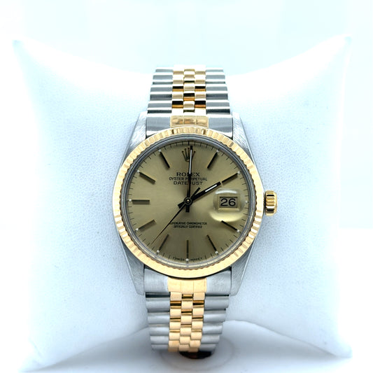 Two-tone Rolex Datejust 36mm with champagne dial, fluted gold bezel, Jubilee bracelet.