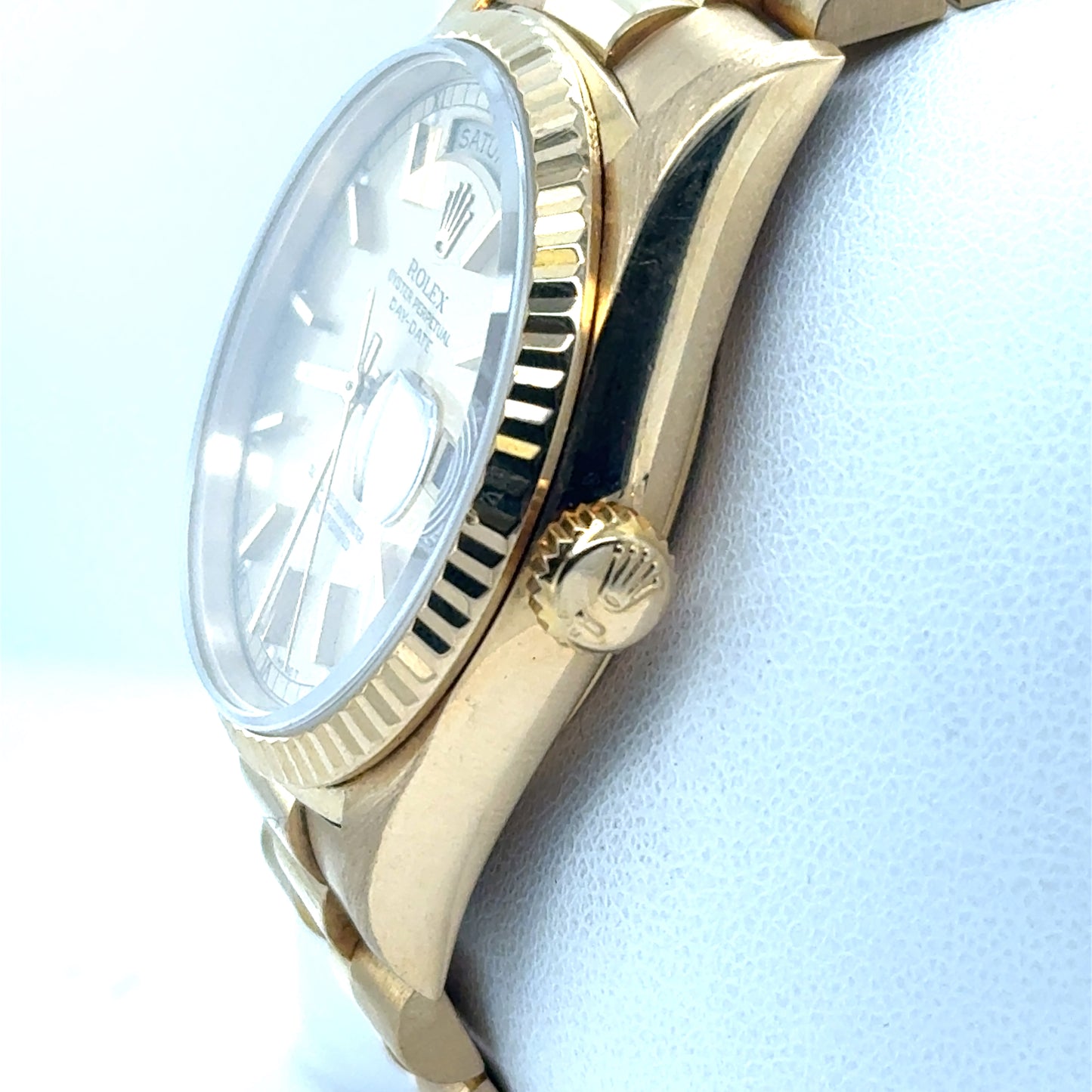 18K yellow gold Rolex Day-Date with fluted bezel, crown, and champagne dial.
