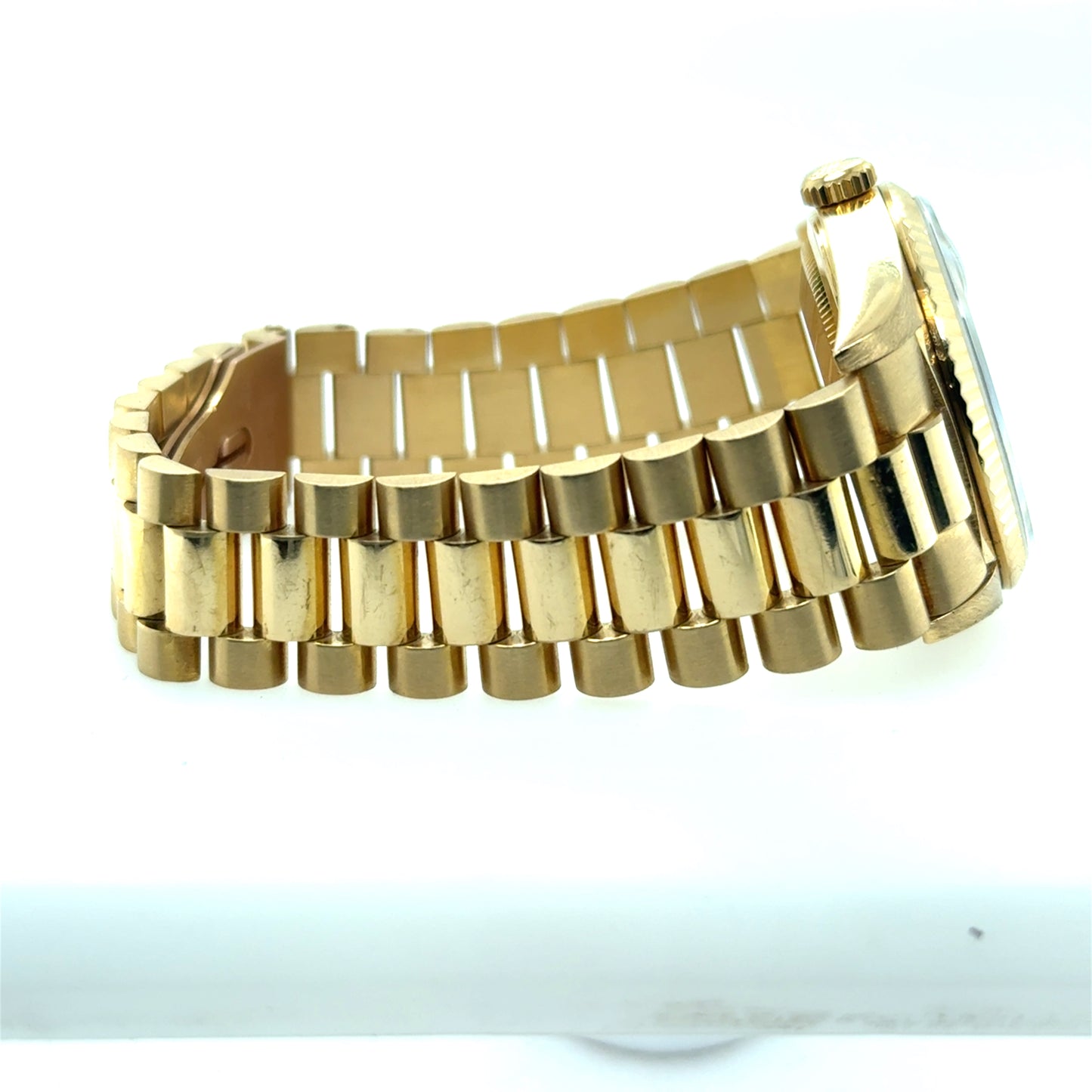 18K yellow gold Day-Date watch with fluted bezel and President bracelet.