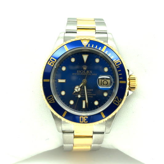 Two-tone stainless steel and yellow gold Submariner with blue dial, blue bezel, date magnifier, and oyster bracelet.