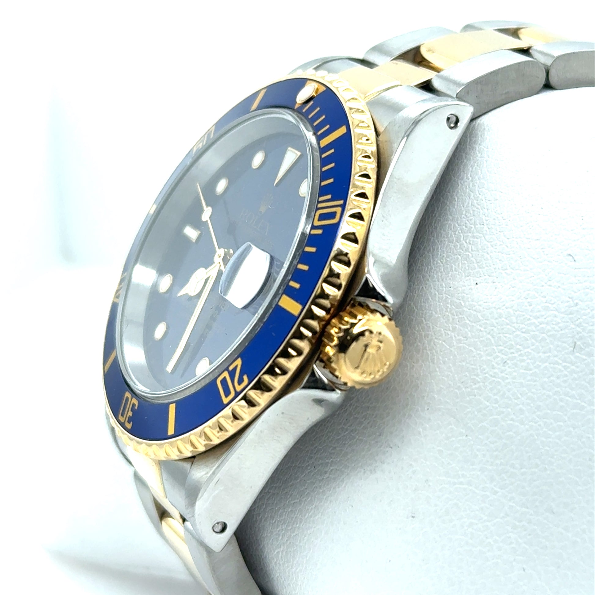 Two-tone stainless steel and yellow gold dive watch with blue bezel, blue dial, date magnifier, and oyster bracelet.