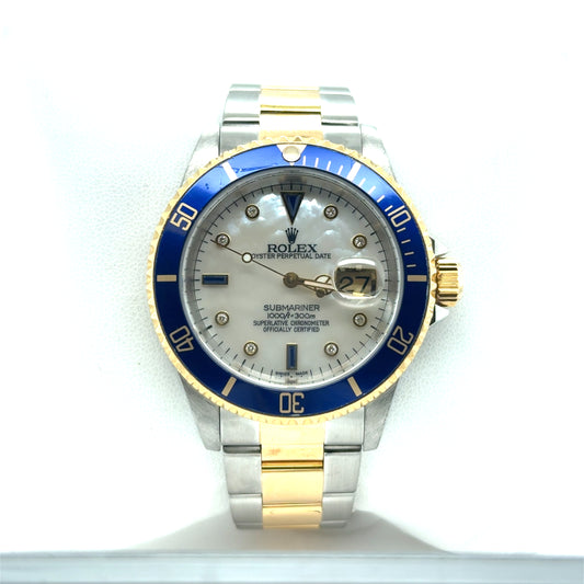 Two-tone stainless steel and yellow gold Submariner with blue bezel, mother-of-pearl dial, diamond markers, and date magnifier.