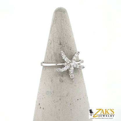 14K white gold ring with diamond pavé starfish on a slender band.