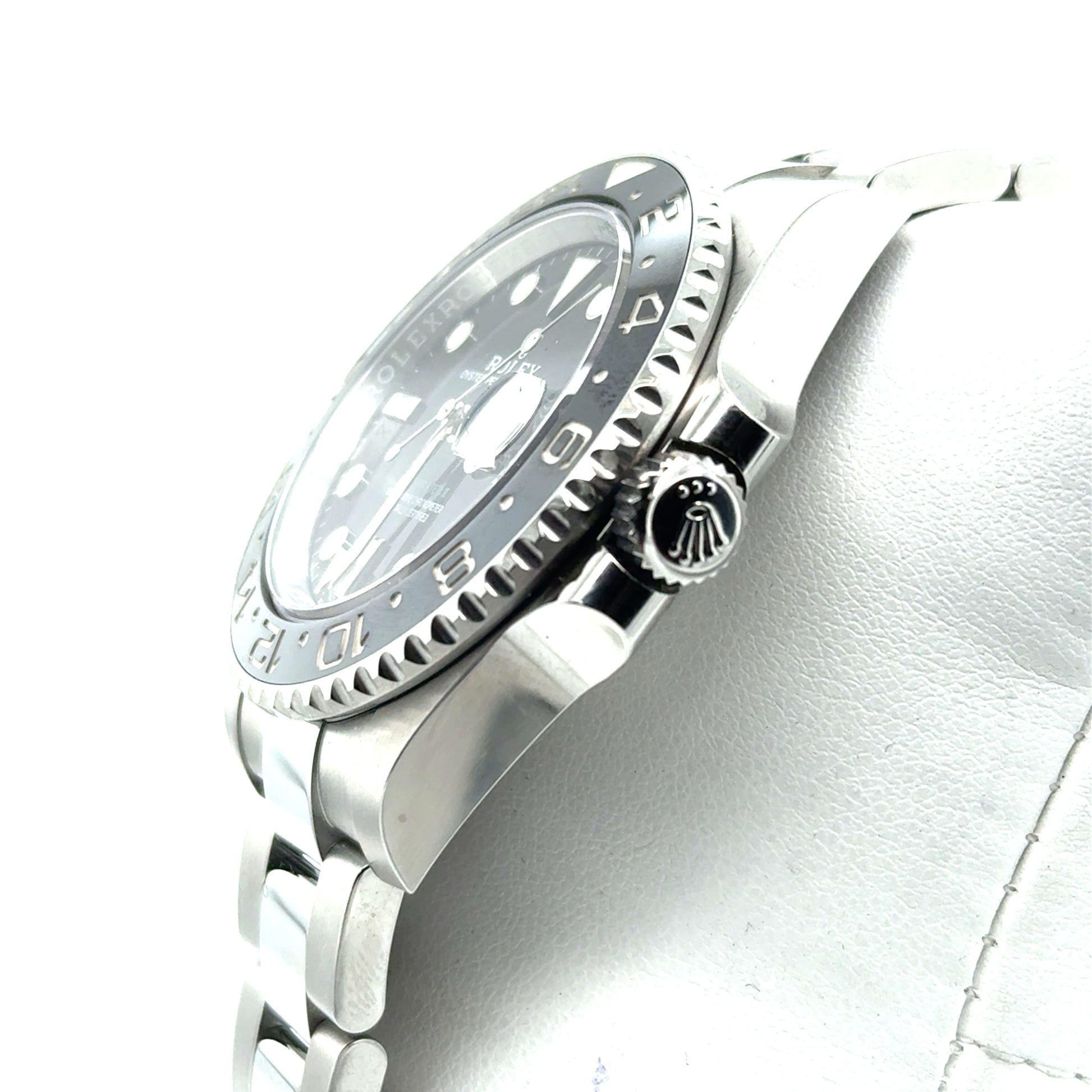 Stainless steel GMT watch with black dial, black‑gray ceramic bezel, Oyster bracelet.