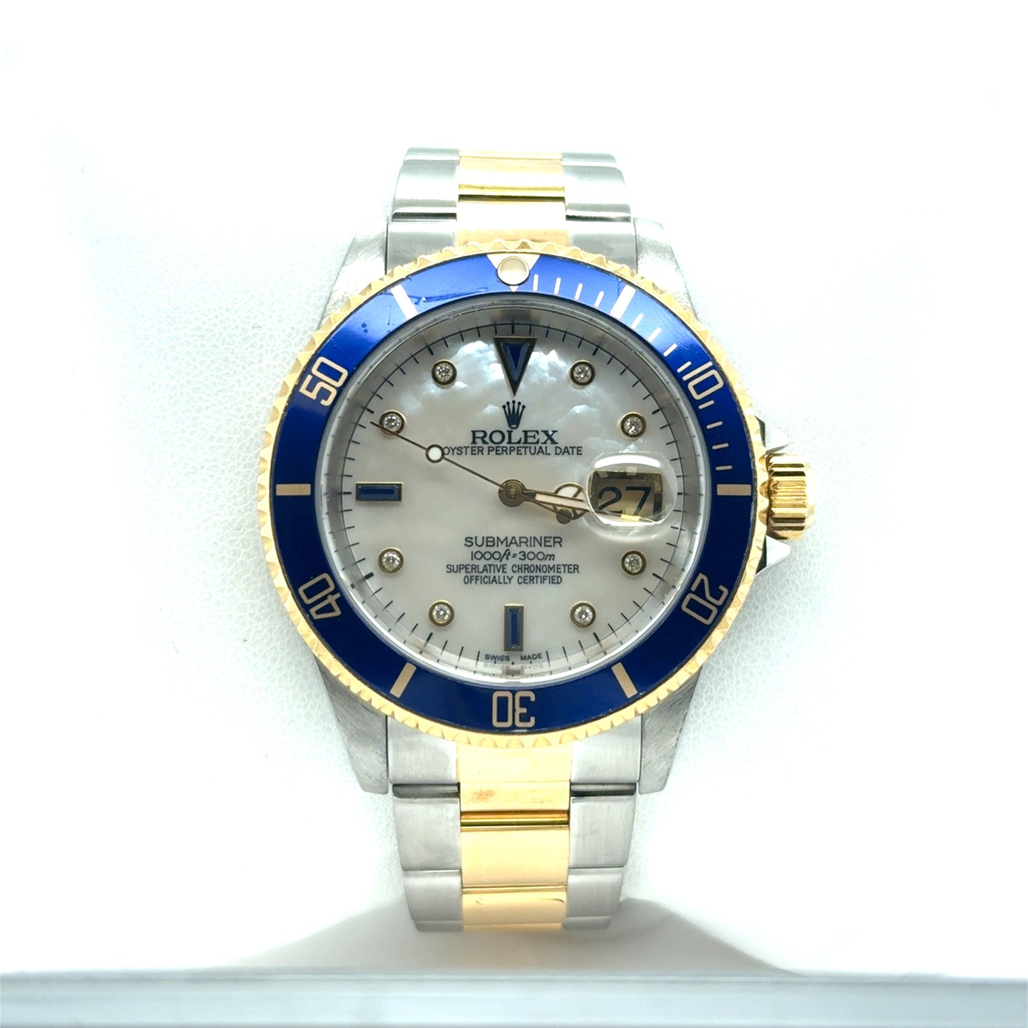 Two-tone stainless steel and yellow gold Submariner with blue bezel, mother-of-pearl dial, diamond markers, and date magnifier.
