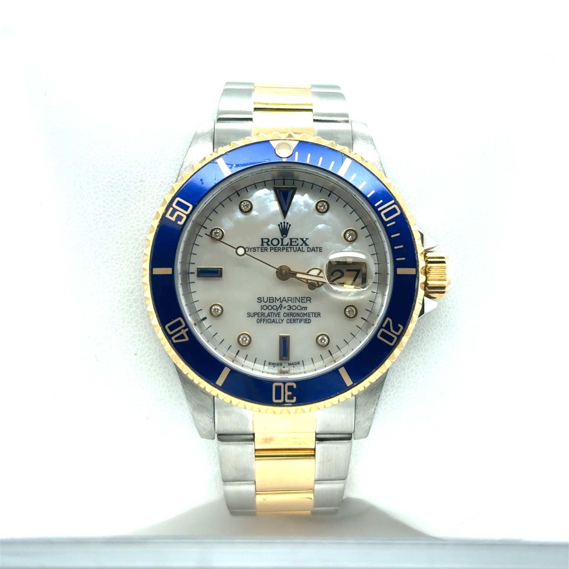 Two-tone stainless steel and yellow gold Submariner with blue bezel, mother-of-pearl dial, diamond markers, and date magnifier.