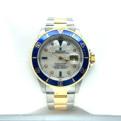 Two-tone stainless steel and yellow gold Submariner with blue bezel, mother-of-pearl dial, diamond markers, and date magnifier.