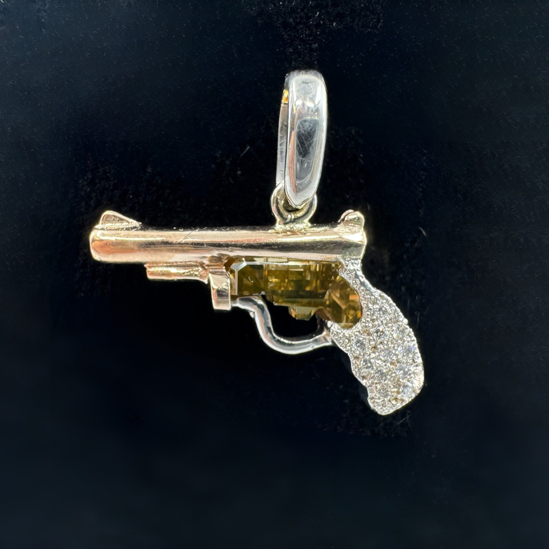 14K rose and white gold pistol pendant with brown-yellow diamond and pavé handle.